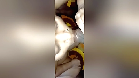 Brunette with round ass is on the bed and she is masturbating