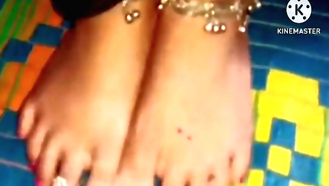 Indian wife watches the sunset from a window and she is happy