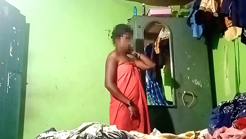 Indian mature woman takes off her dress in a hot bath