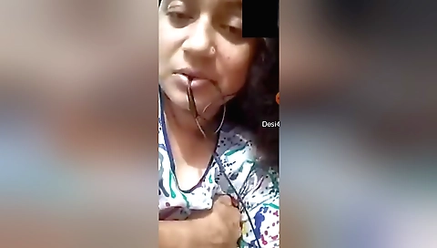 Indian brunette is showing off her boobs and pussy