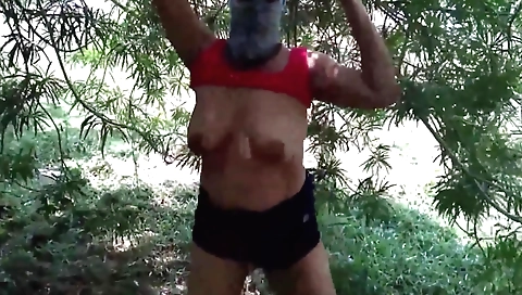 Indian woman with big tits is playing with a big cock outdoors