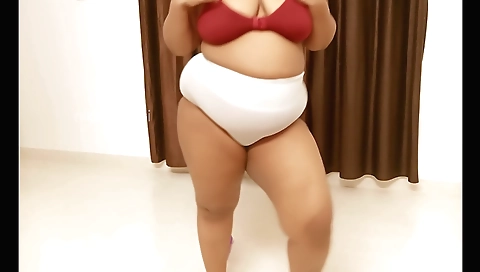 Solo girl in black dress shows off her big tits and booty